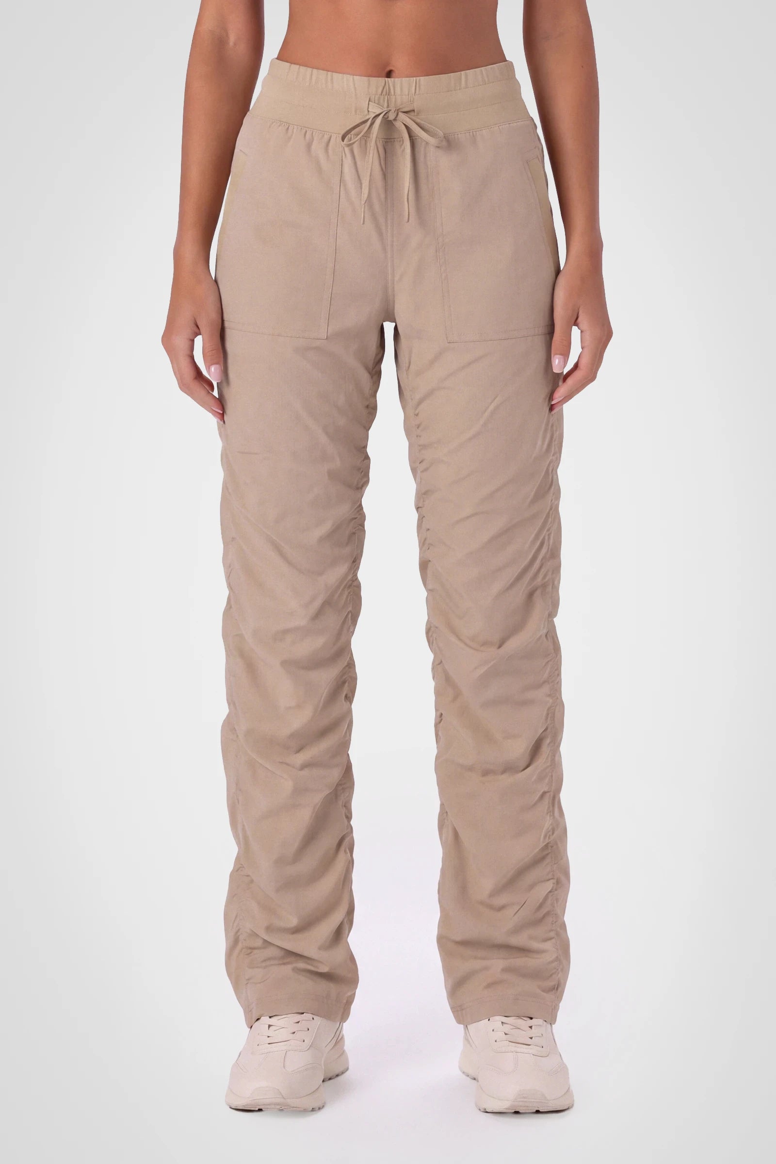 Women’s Doeskin Adventurous Pant, front studio view showing the elastic drawstring waist, utility patch pockets and gathered cuffs.