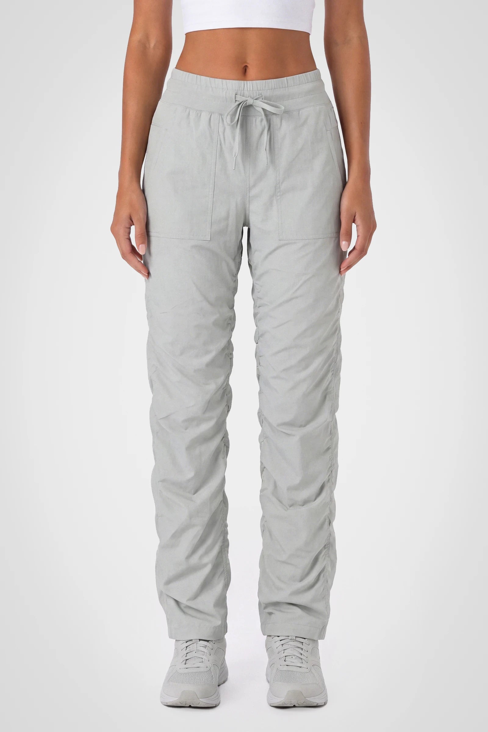 Women’s Harbor Mist Adventurous Pant, front studio view showing the elastic drawstring waist, utility patch pockets and gathered cuffs.