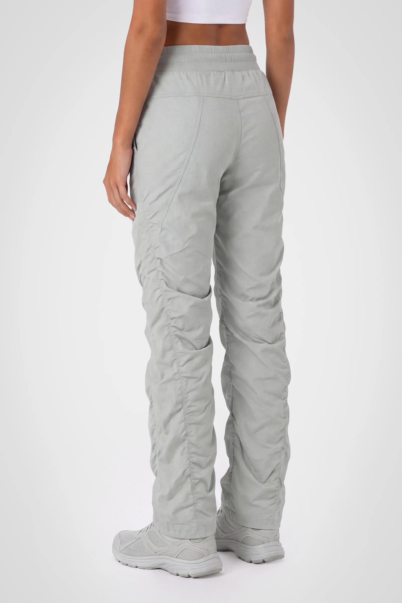 Women’s Harbor Mist Adventurous Pant, three-quarter studio view showing the tapered leg and gathered hem.