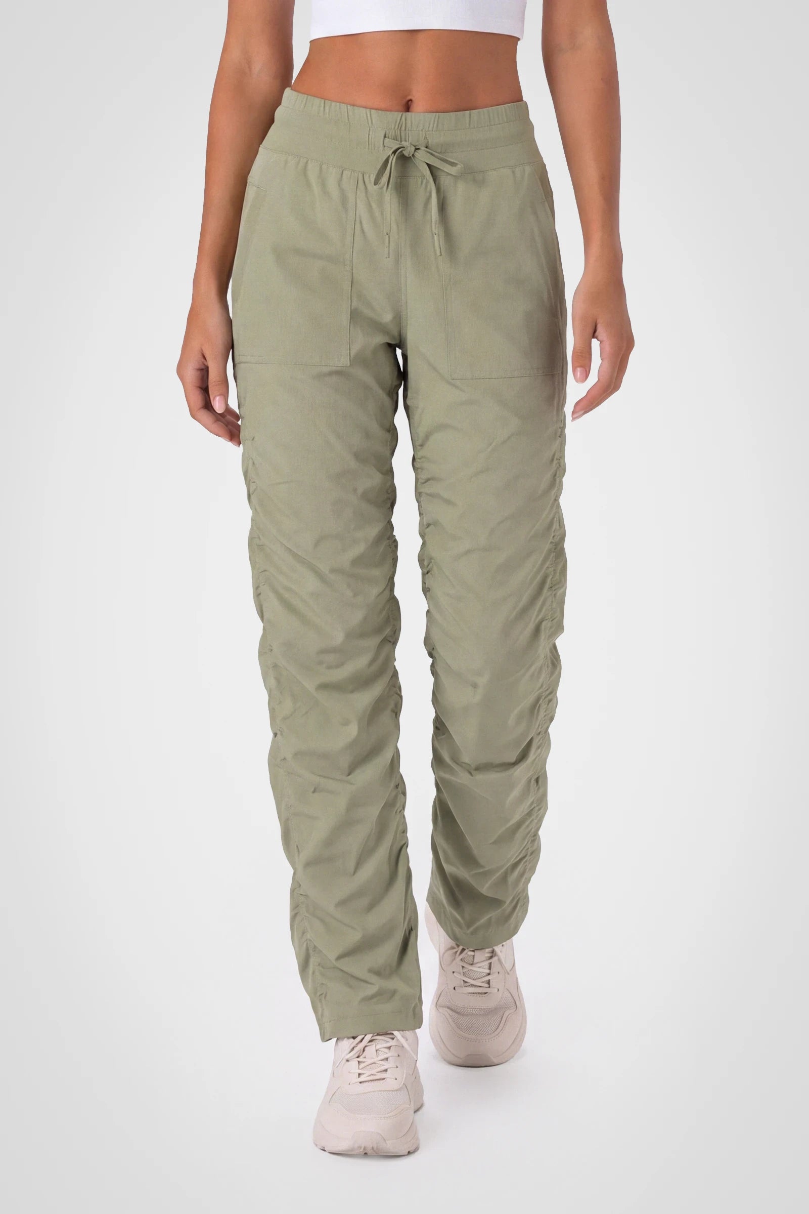 Women’s Silver Sage Adventurous Pant, front studio view showing the elastic drawstring waist, utility patch pockets and gathered cuffs.